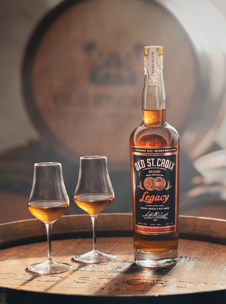 bottle of XO Legacy and two nosing glasses on a barrel